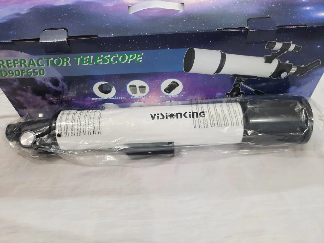 Visionking-branded optical tube in its factory wrapping, in front of the retail box.