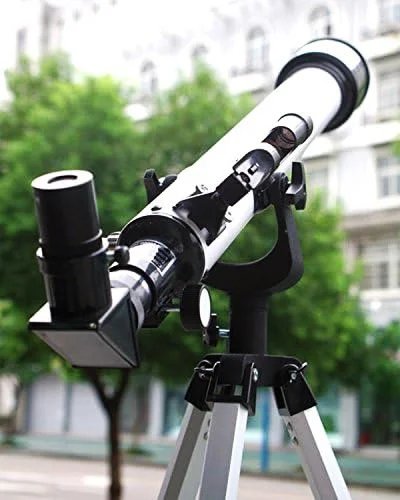 Telescope outdoors with diagonal and eyepiece fitted at the back of its tube