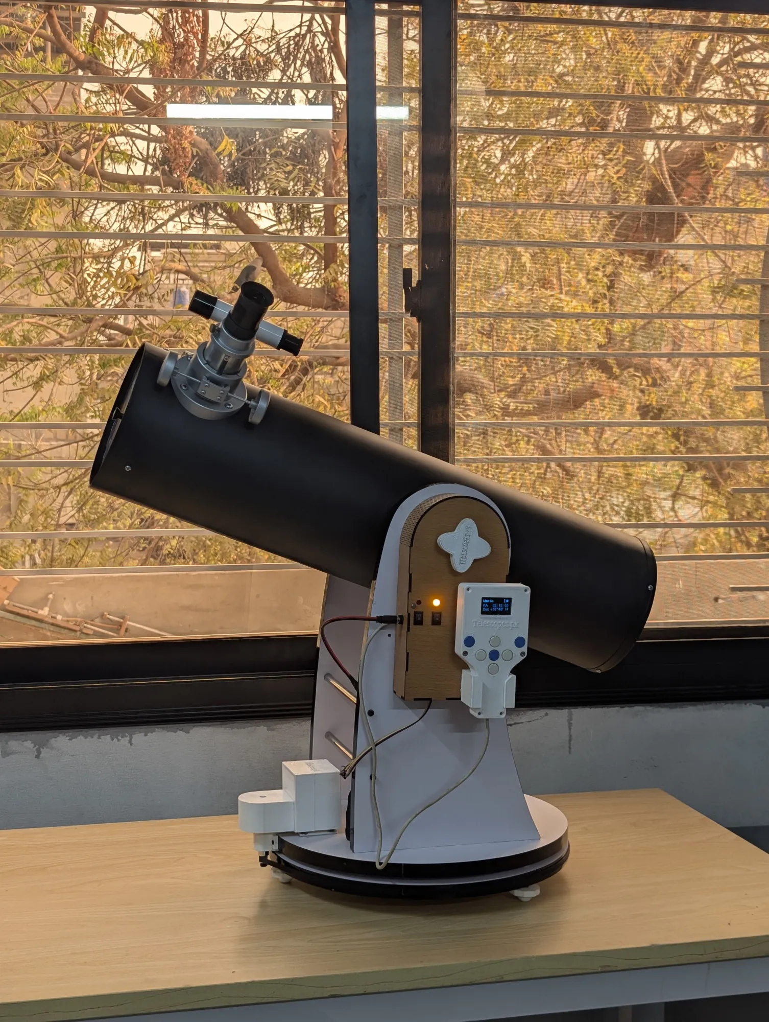 RVision GT 6-750 beside a window, with its hand controller mounted on the base.