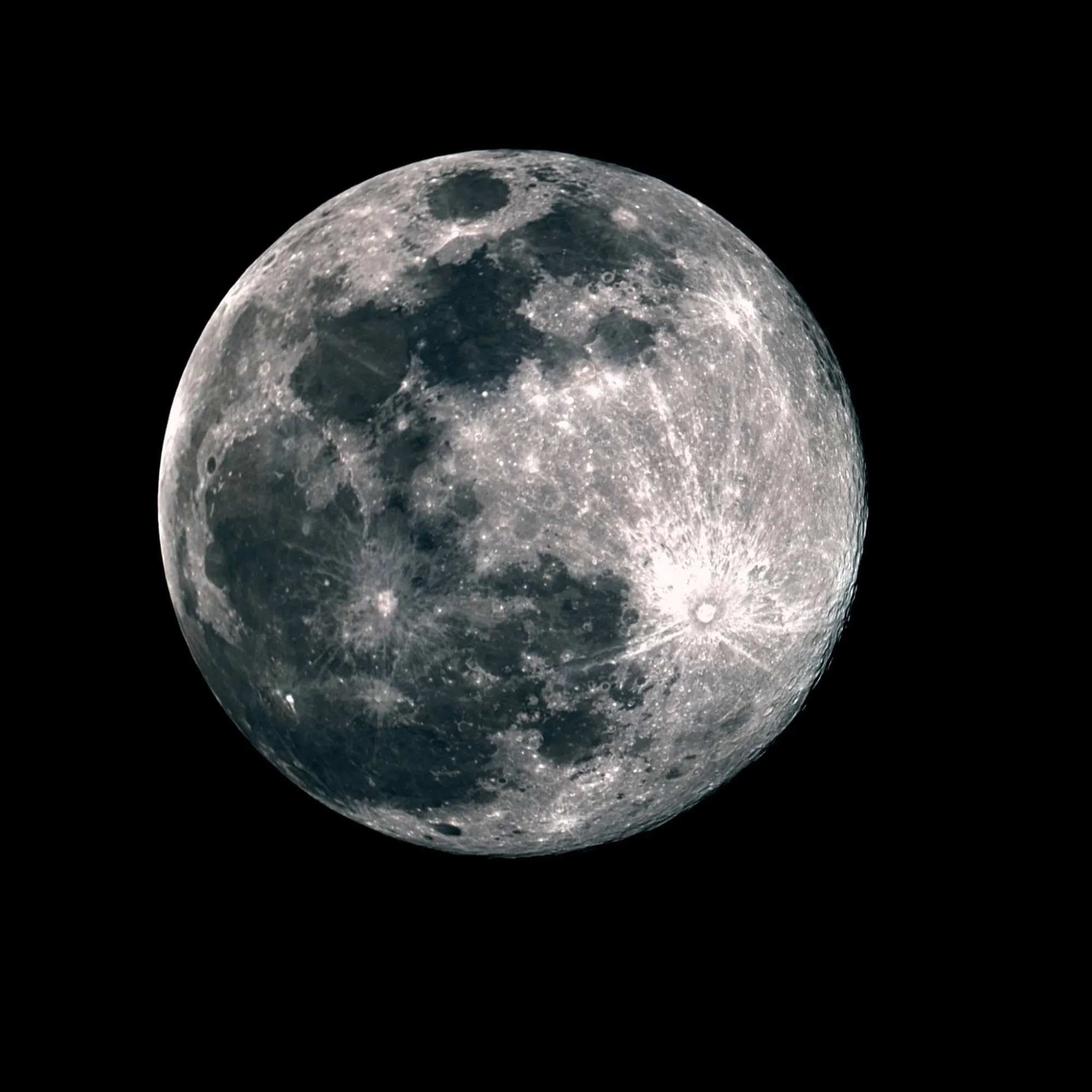 A detailed photograph of the full Moon with its bright ray craters.