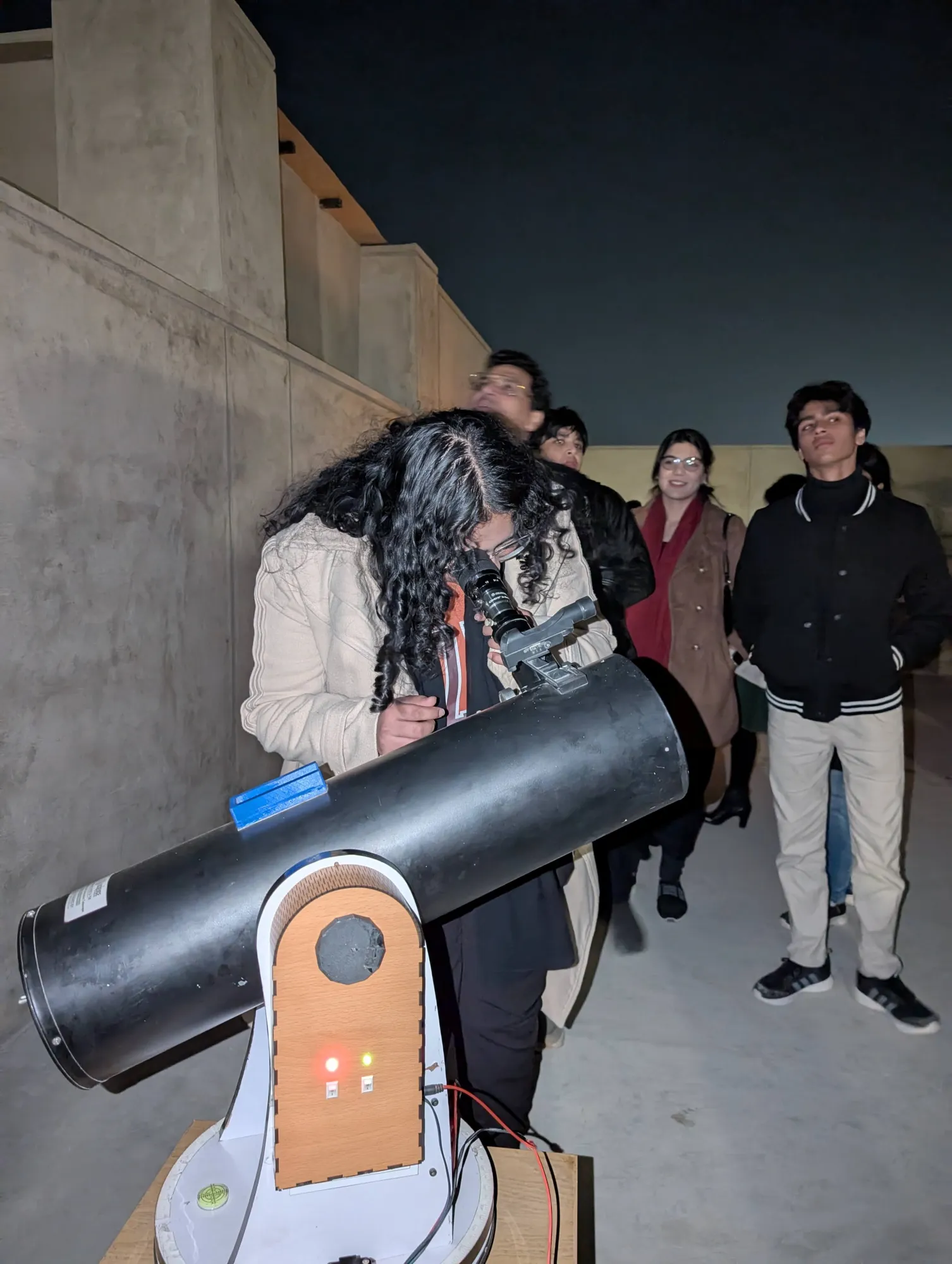 An observer at the eyepiece of the RVision GT, with a queue behind her.